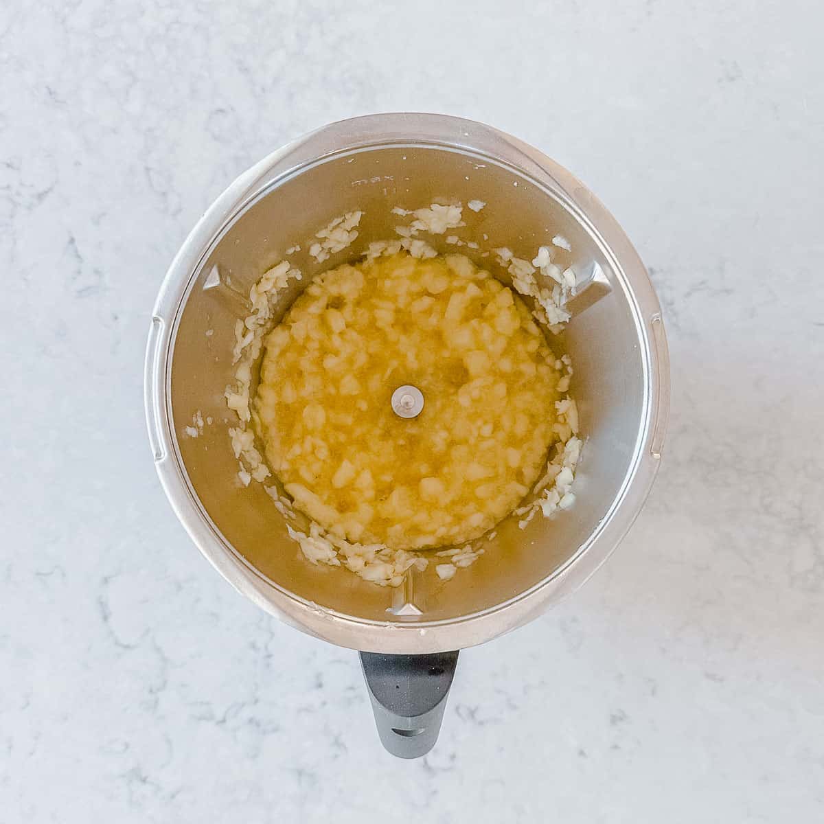 Apple sauce in a metal jug.