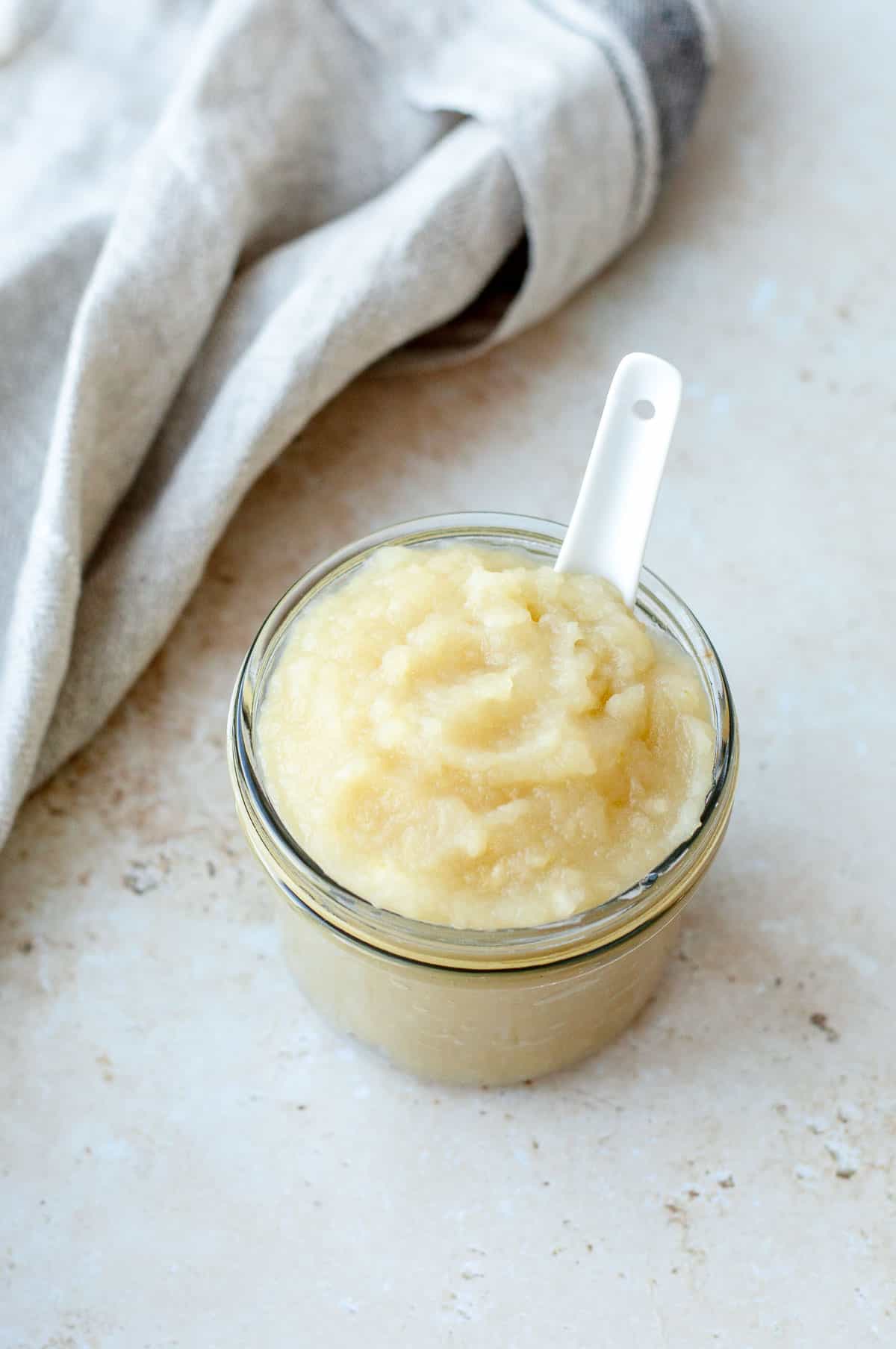 Apple sauce in a glass jar.