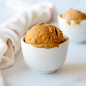 Coffee Ice Cream in a white bowl on a white background.