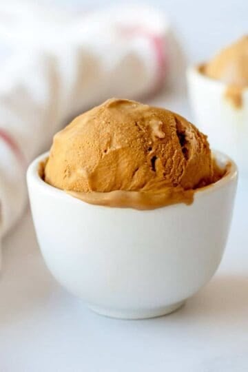 Coffee Ice Cream in a white bowl on a white background.
