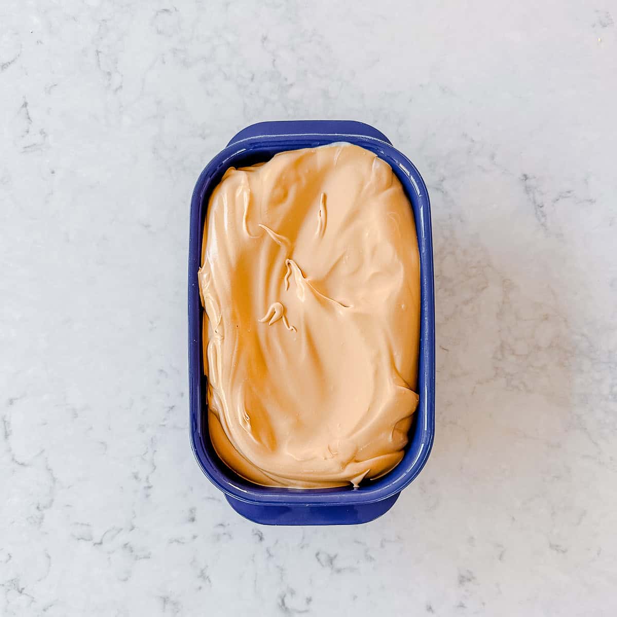 Coffee Ice Cream in a purple plastic container.