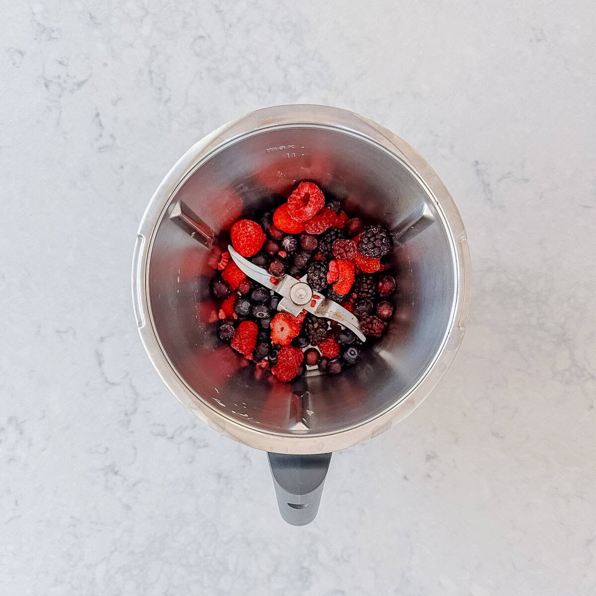Mixed berries in a Thermomix Bowl.
