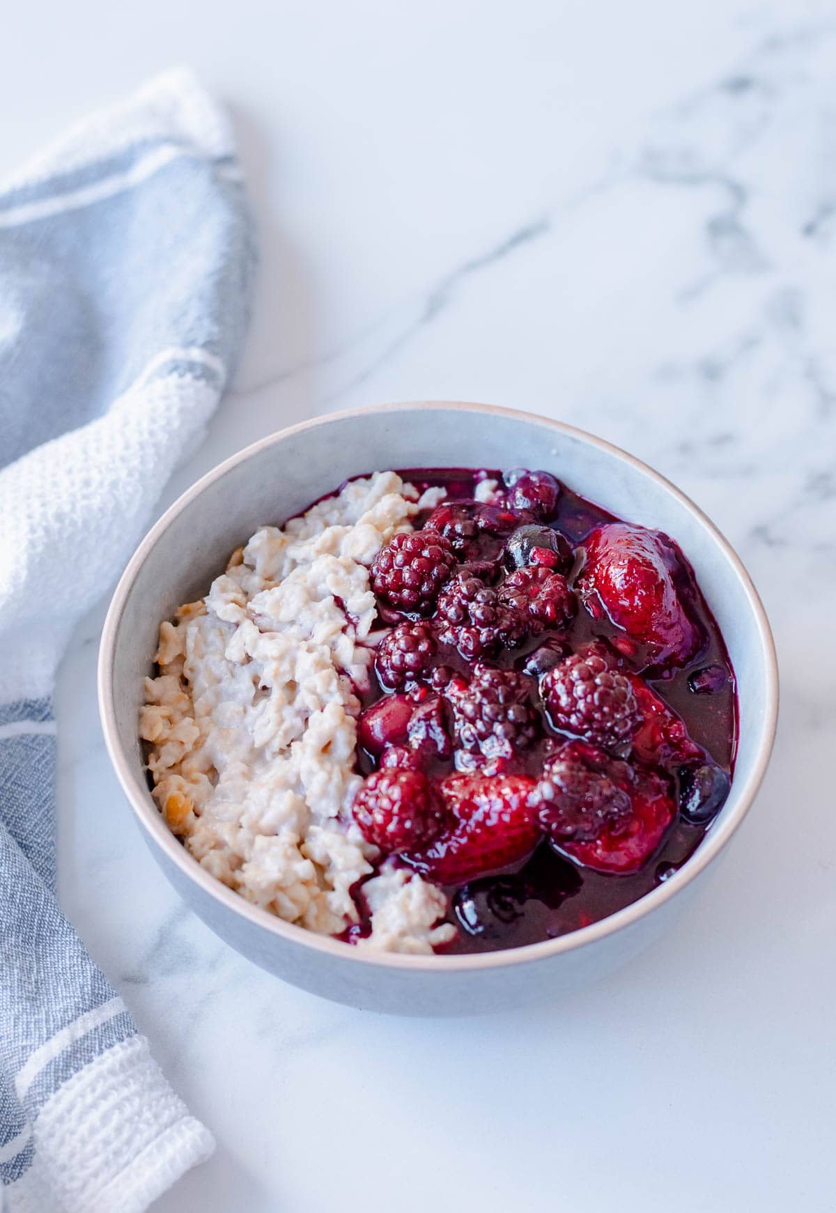 a bowl of porridge and mixed berry compote