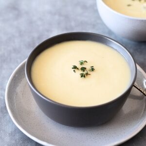 2 Bowls of Celeriac Soup on a grey table.