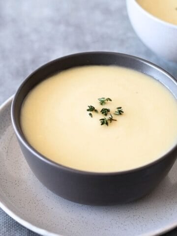 2 Bowls of Celeriac Soup on a grey table.