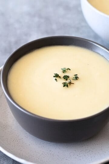 2 Bowls of Celeriac Soup on a grey table.