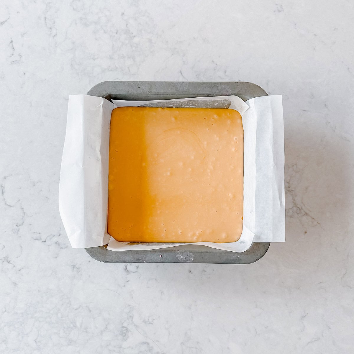 Caramel fudge in a square baking tin.