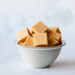 Squares of Caramel Fudge in a grey bowl.