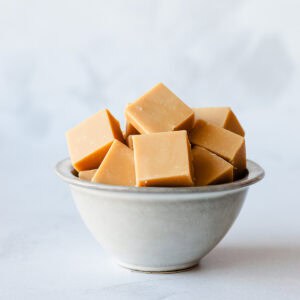 Squares of Caramel Fudge in a grey bowl.