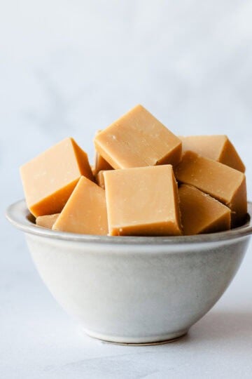Squares of Caramel Fudge in a grey bowl.