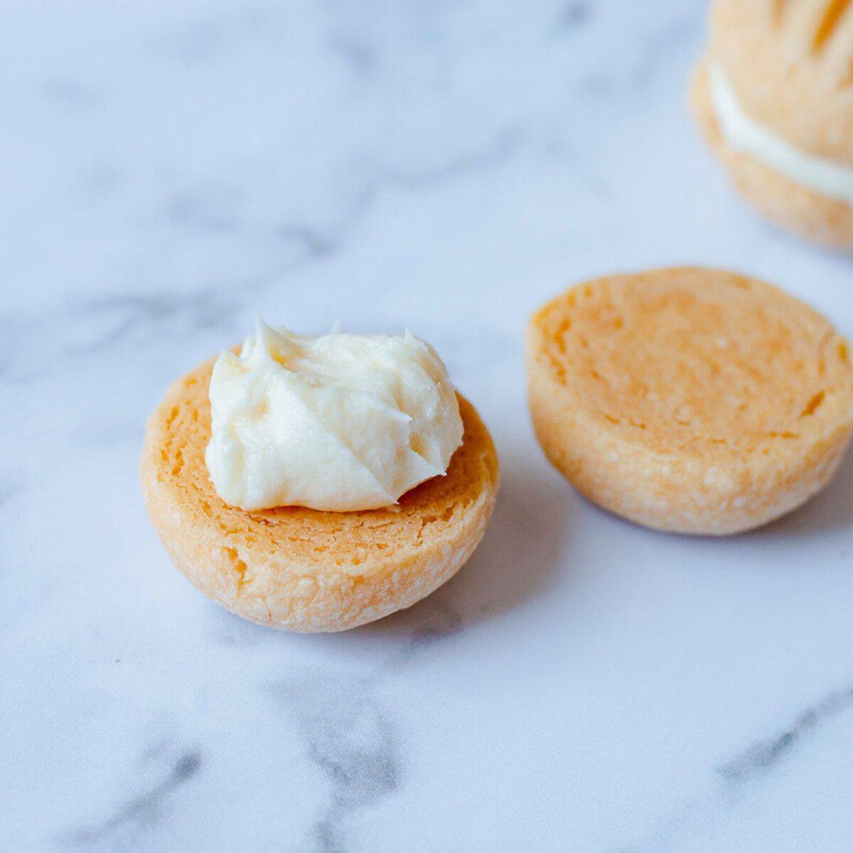 Half a melting moment biscuit with icing on it.