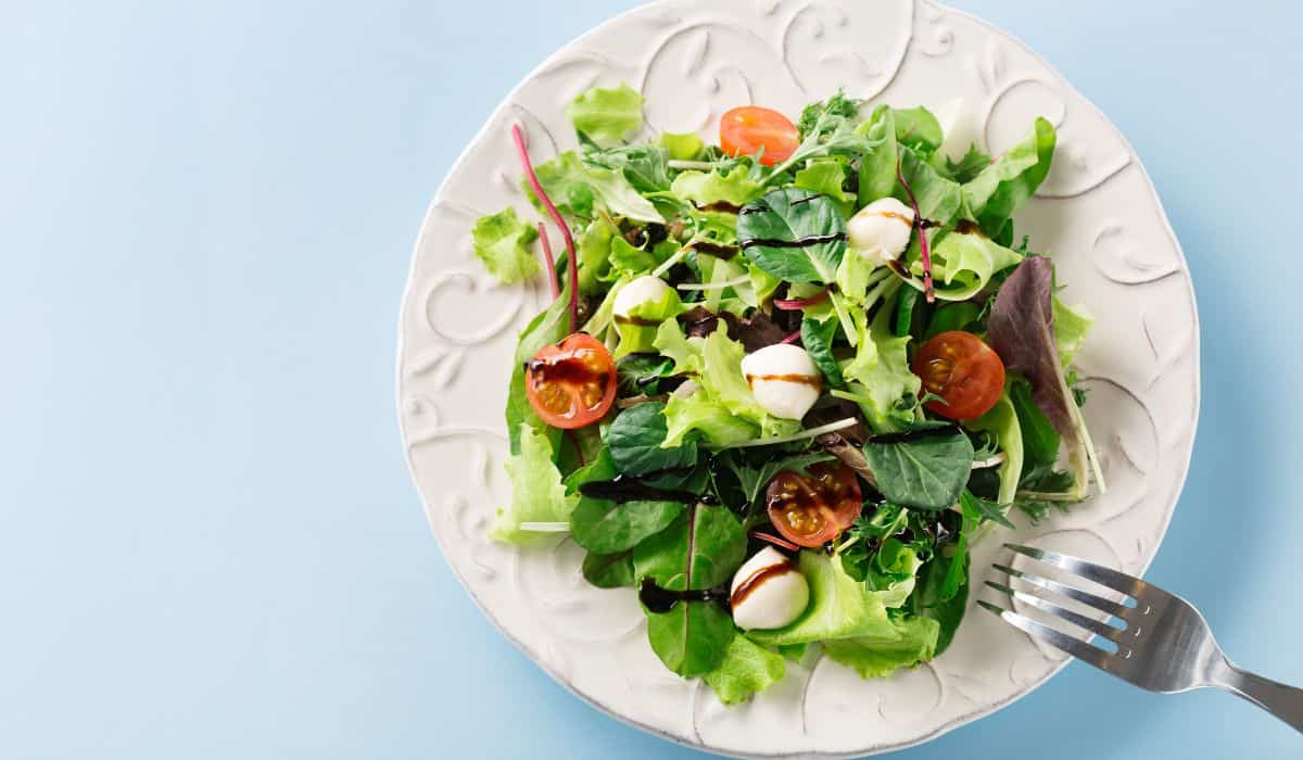 Top down view of a simple salad, with balsamic glaze drizzled over the top.