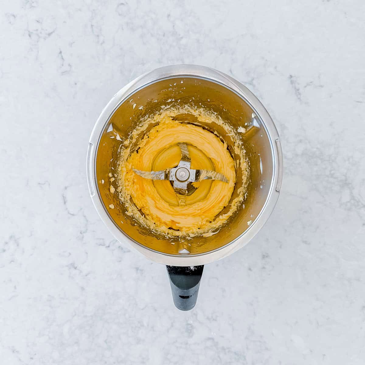 Softened butter in the Thermomix bowl, seen from above.