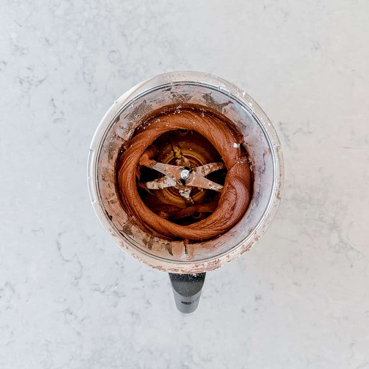 Smooth chocolate buttercream whisked around the butterfly whisk in the Thermomix bowl.